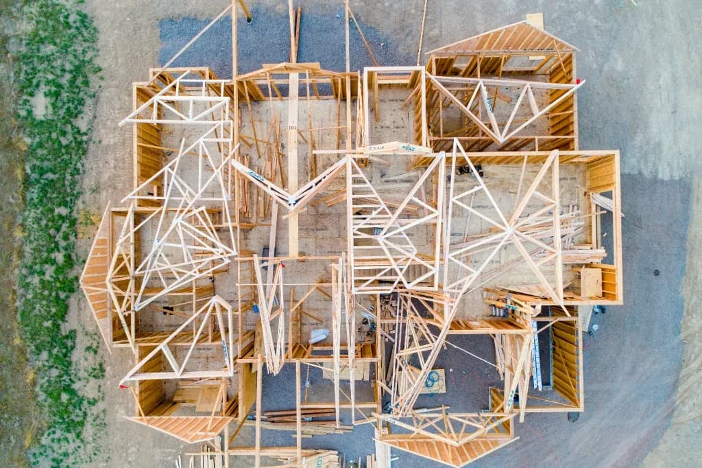 Aerial view of wooden house framing and roof trusses on a new build
